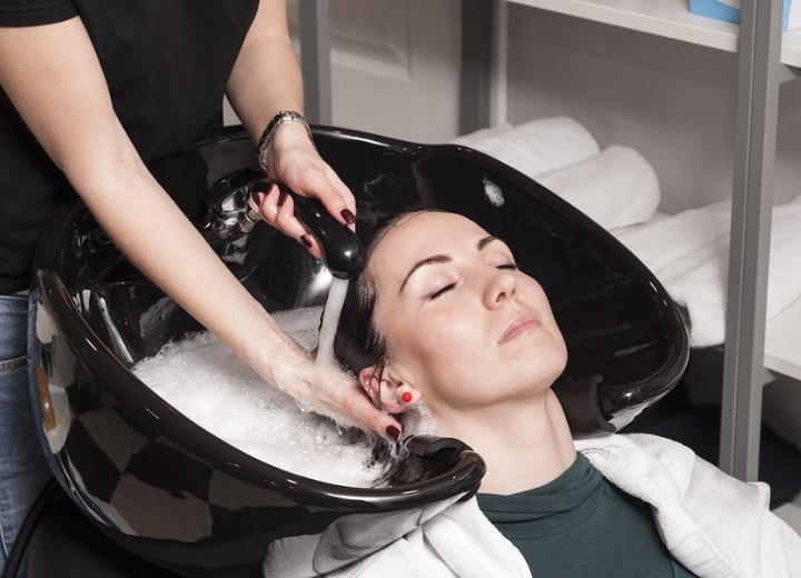 Laver les cheveux d'une cliente dans un salon de coiffure